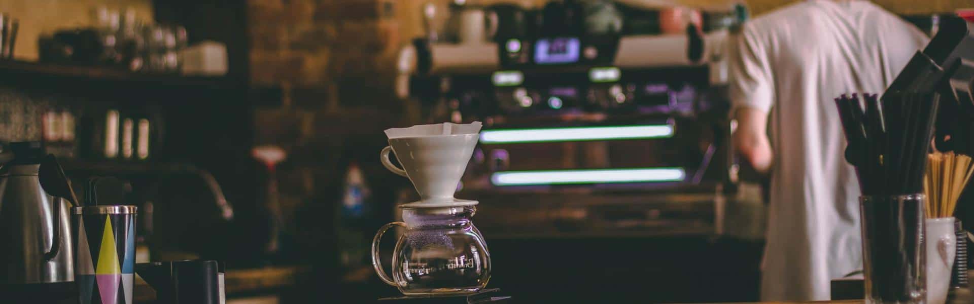 Man standing beside espresso machine