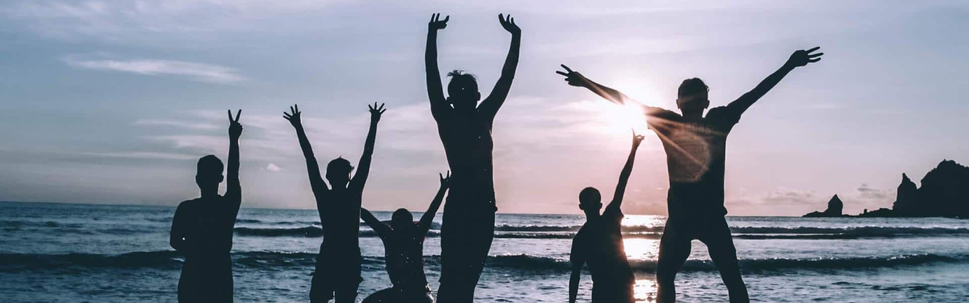 Silhouette of people by the seashore