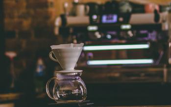 Man standing beside espresso machine